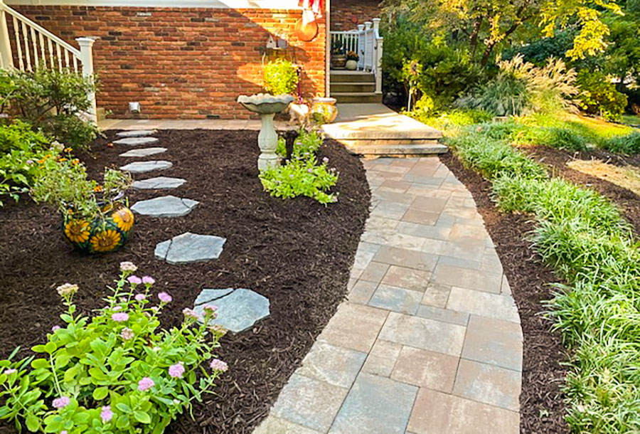 Image of a hardscape, random patten front walkway and a planting refresh installed by JMC Landscaping